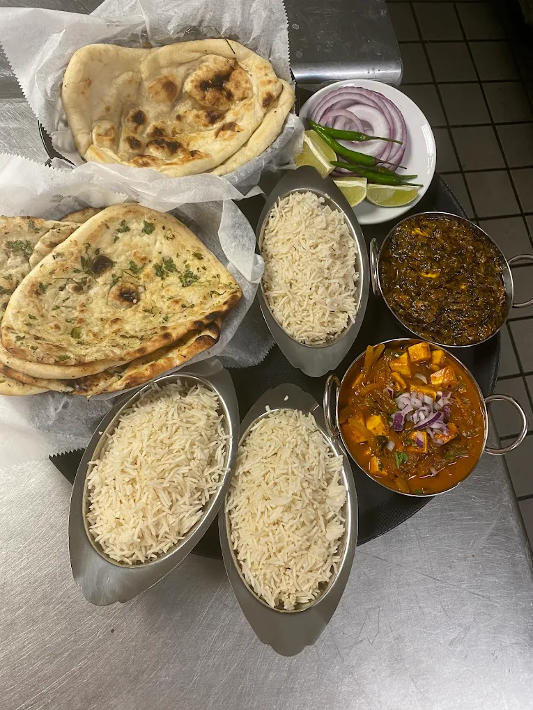A Nepali thali platter with rice, daal, curry, saag and achar